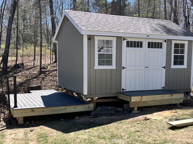 Utility shed with a small Trex landing in Bedford