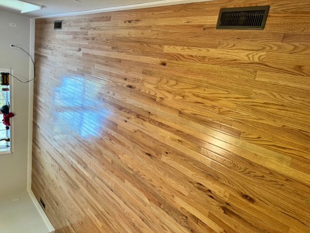 New hardwood flooring installed across a Merrimack living room